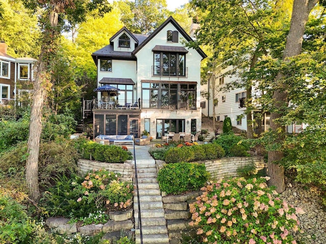 back of house with a patio, stairway, and stucco siding