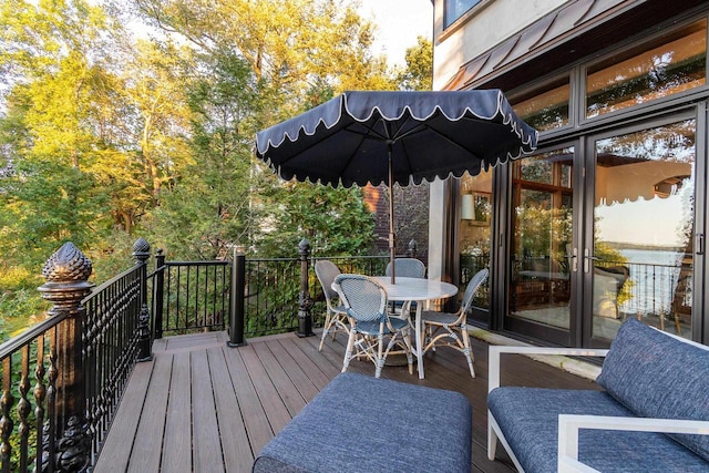 wooden terrace featuring outdoor dining area