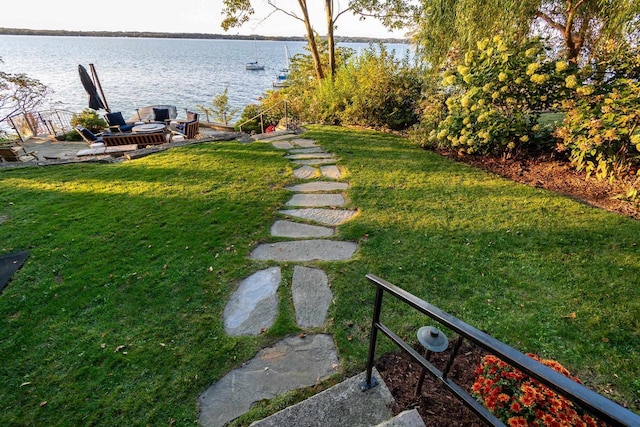 view of yard featuring a dock and a water view