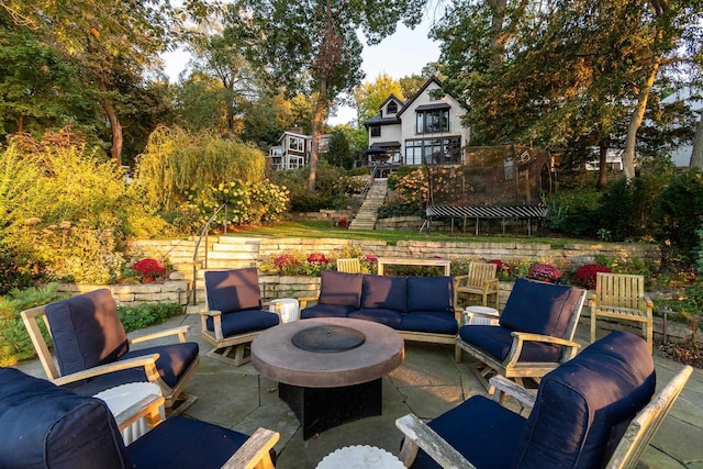 view of patio / terrace featuring an outdoor living space with a fire pit