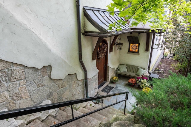 doorway to property with stucco siding