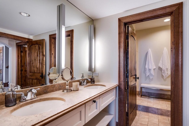 bathroom featuring double vanity and a sink