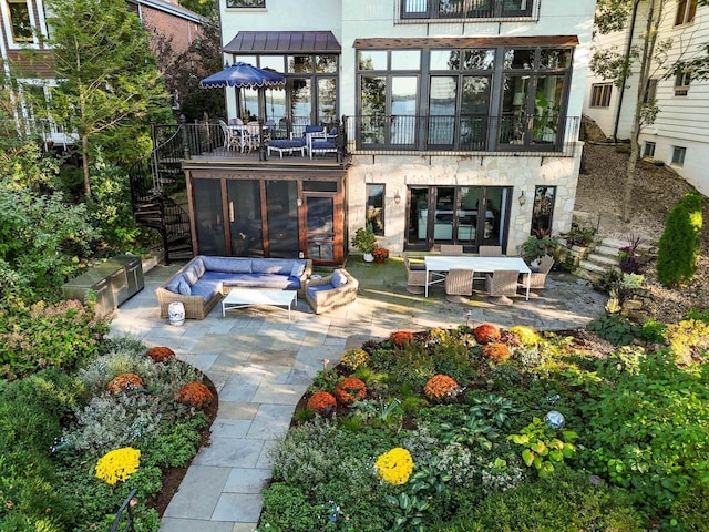 back of property featuring stairway, a patio, metal roof, and a standing seam roof