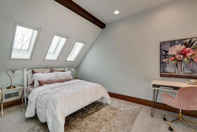 carpeted bedroom featuring lofted ceiling with skylight and baseboards