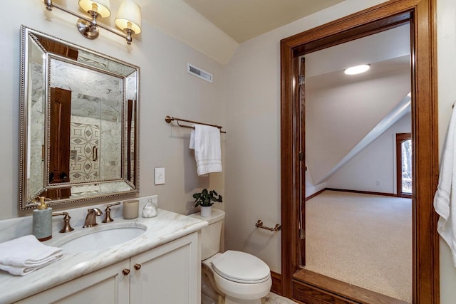 bathroom with vanity, toilet, baseboards, and visible vents