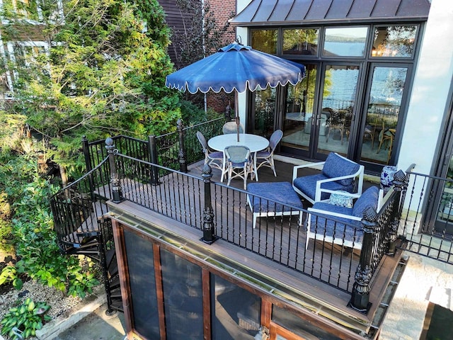 wooden terrace featuring outdoor dining area