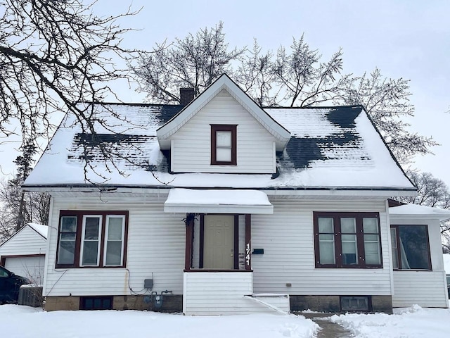 view of front of property with a garage and an outbuilding