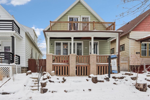 view of front facade featuring covered porch and a balcony