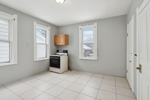 kitchen featuring light tile patterned floors and gas range gas stove
