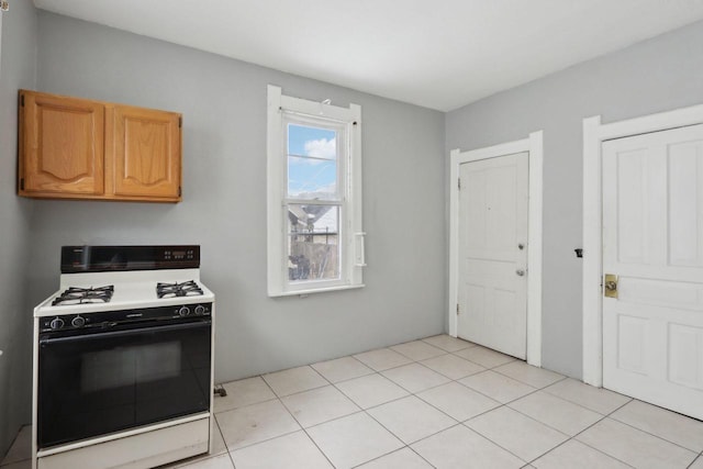kitchen featuring gas range oven and light tile patterned floors