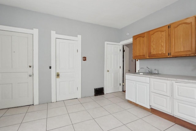kitchen with light tile patterned floors and sink