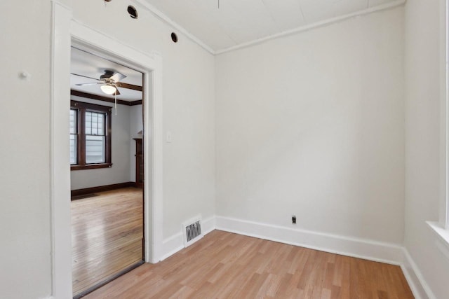 empty room with light hardwood / wood-style floors, ceiling fan, and ornamental molding
