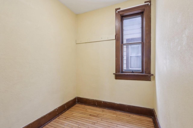unfurnished room with a healthy amount of sunlight and light hardwood / wood-style floors