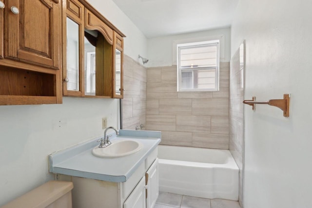 bathroom with vanity, tile patterned flooring, and tiled shower / bath combo