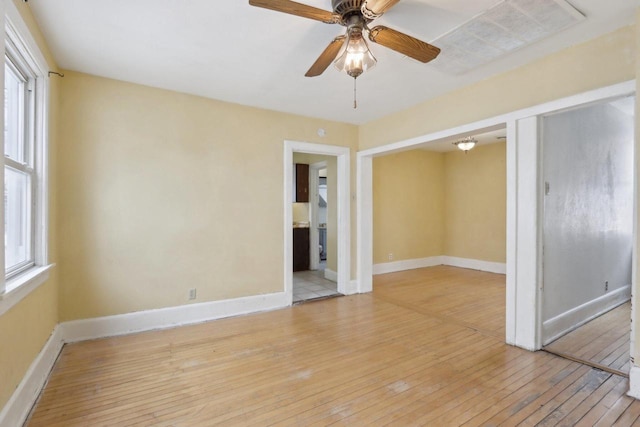 unfurnished room featuring light wood-type flooring and ceiling fan