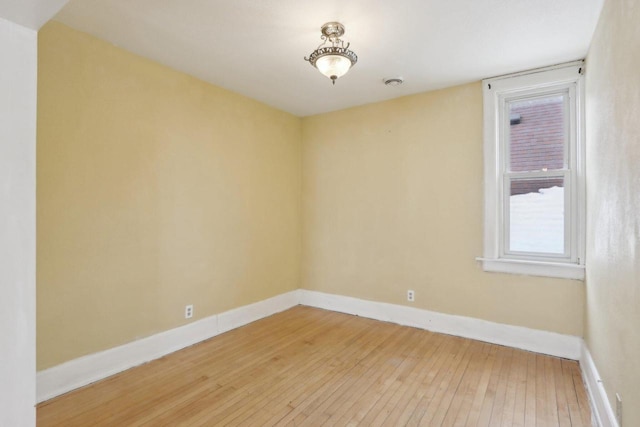 spare room featuring wood-type flooring