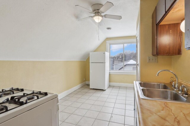 kitchen with white appliances, vaulted ceiling, sink, light tile patterned floors, and ceiling fan
