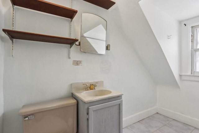 bathroom featuring toilet, vanity, and tile patterned flooring