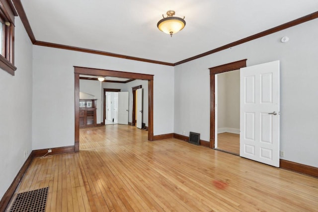 unfurnished room featuring light hardwood / wood-style flooring and crown molding