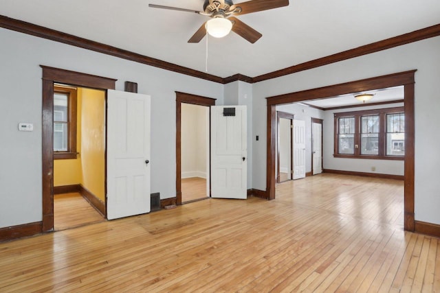 spare room with ceiling fan, ornamental molding, and light hardwood / wood-style floors