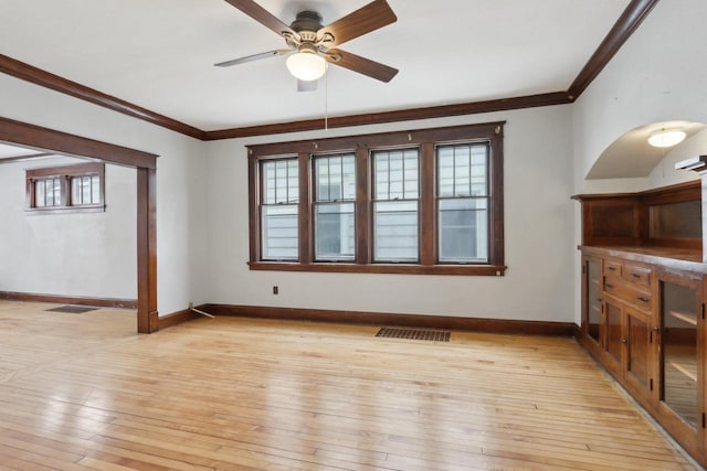 unfurnished living room with ceiling fan, light hardwood / wood-style floors, and crown molding