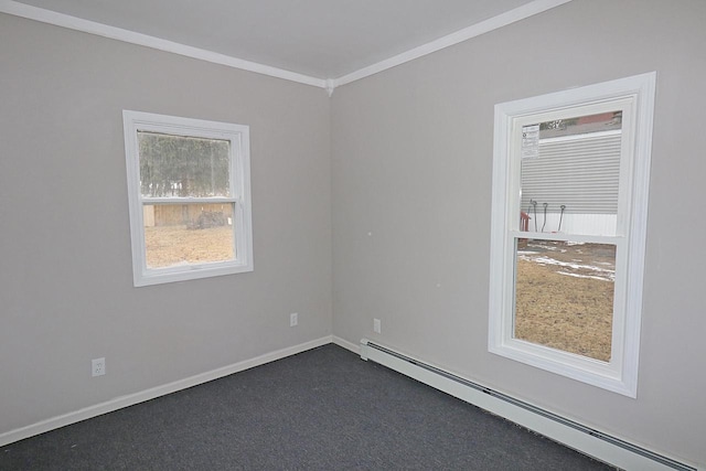 carpeted empty room featuring crown molding and a baseboard heating unit