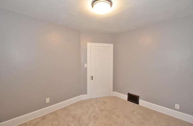 empty room featuring light colored carpet