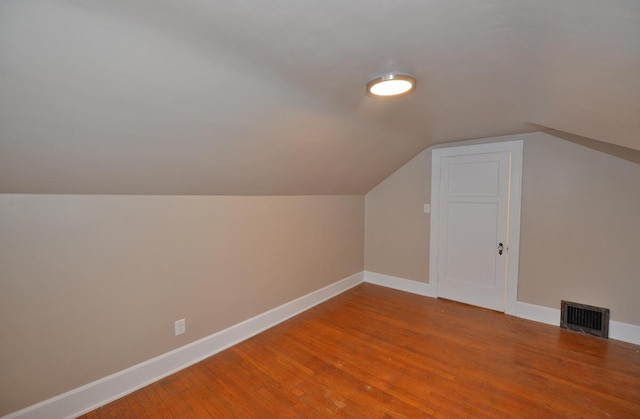 bonus room with vaulted ceiling and hardwood / wood-style floors