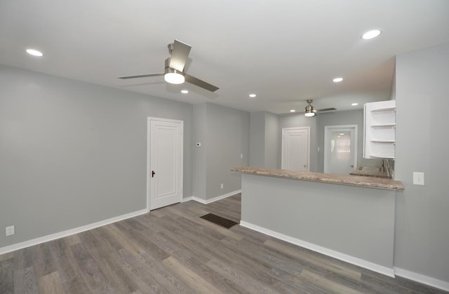 kitchen with white cabinetry, ceiling fan, dark hardwood / wood-style floors, and kitchen peninsula