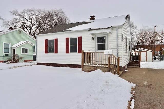 view of front of house with a storage unit