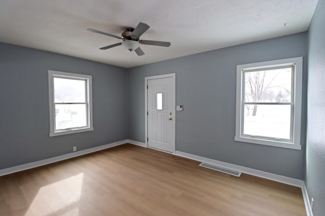 entrance foyer with ceiling fan and light hardwood / wood-style flooring