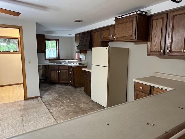 kitchen featuring sink, dark brown cabinets, and white refrigerator