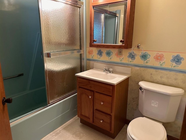 full bathroom with vanity, combined bath / shower with glass door, and toilet