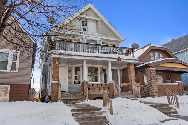 view of front of house featuring covered porch and a balcony