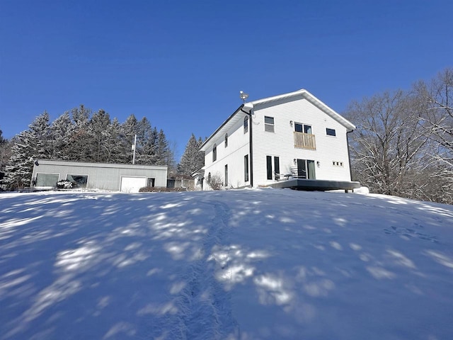 snow covered house with an outbuilding