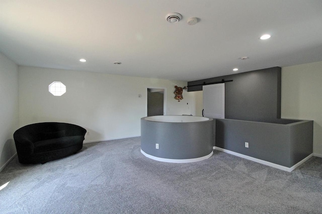 interior space with a barn door, carpet flooring, recessed lighting, and baseboards