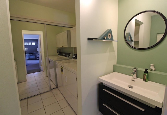 bathroom with tile patterned floors, separate washer and dryer, and a sink