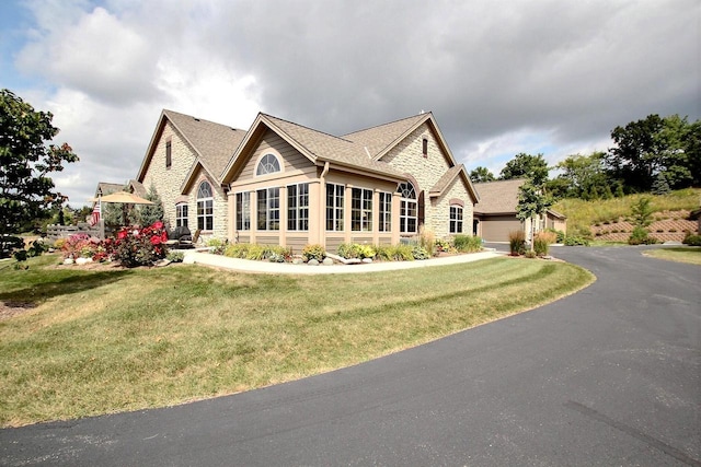 view of front of property featuring a garage and a front lawn