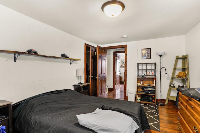 bedroom with dark hardwood / wood-style floors