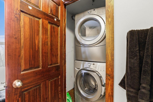 washroom with stacked washing maching and dryer