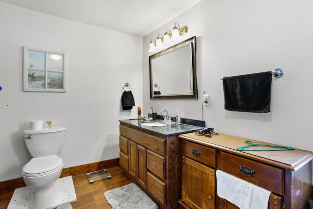 bathroom featuring vanity, hardwood / wood-style floors, and toilet