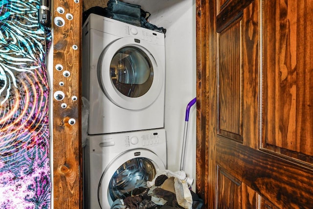 laundry area with stacked washer and dryer