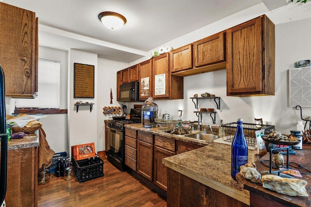 kitchen featuring dark hardwood / wood-style floors, sink, and black appliances