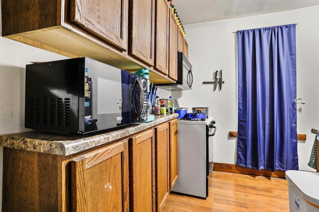 kitchen featuring gas range gas stove and light wood-type flooring