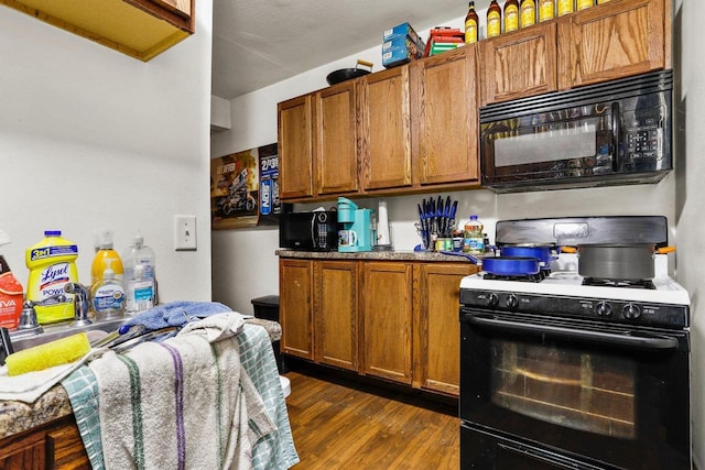 kitchen featuring dark hardwood / wood-style flooring and gas stove