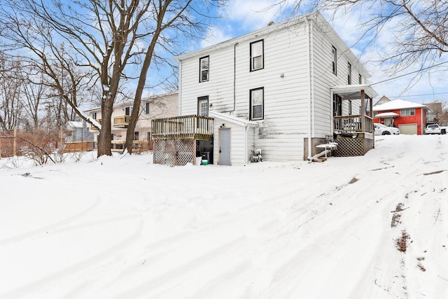 view of snow covered rear of property