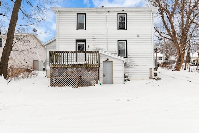 snow covered property with a deck