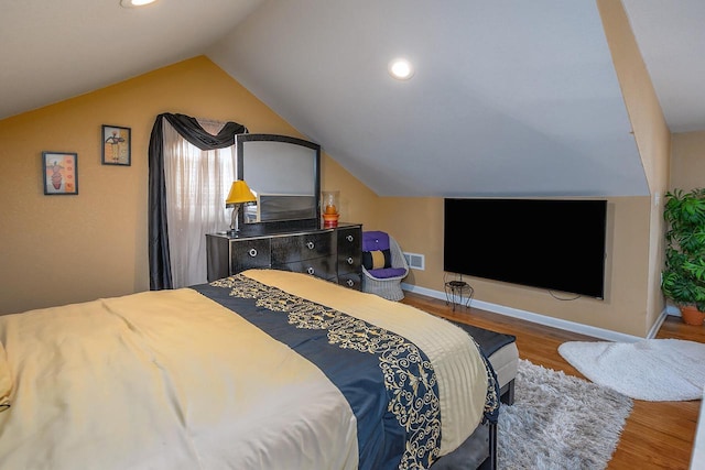 bedroom with wood-type flooring and vaulted ceiling