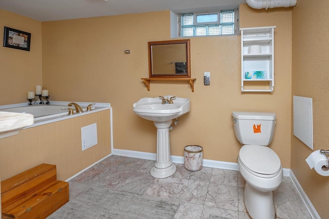 bathroom featuring a bath and toilet