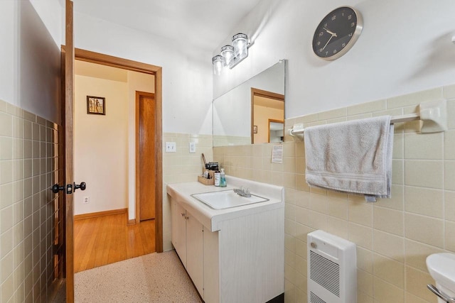 bathroom featuring tile walls and vanity